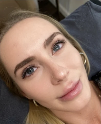 Client with a finished lash set and shaped brows, eyes open